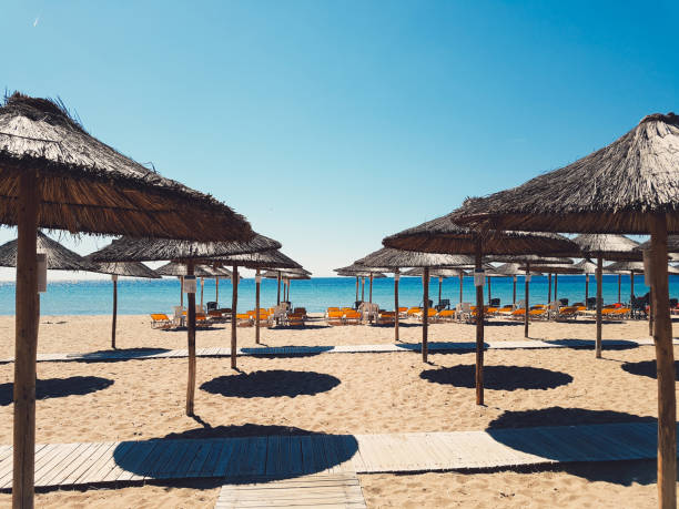 istock Easy Chairs and Umbrellas on Beach 1047001218