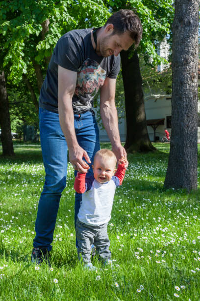 istock Happy baby boy making his first steps with his father 1047001746