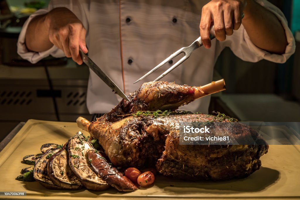 Carving Lamb Carving of Roasted lamb meat Carving Set Stock Photo