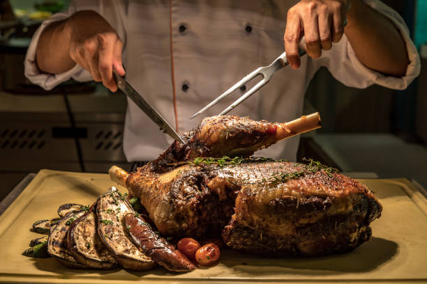 Carving Lamb Carving of Roasted lamb meat carving set stock pictures, royalty-free photos & images