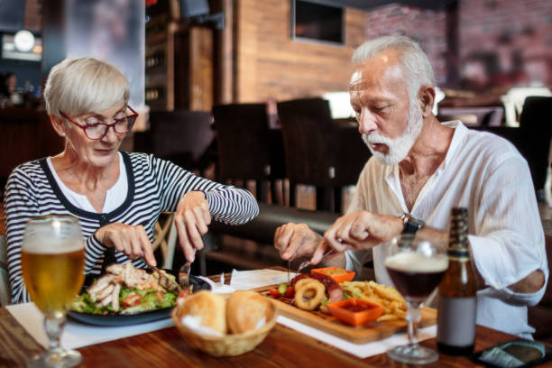 istock Senior couple eating in the restaurant 1047007108