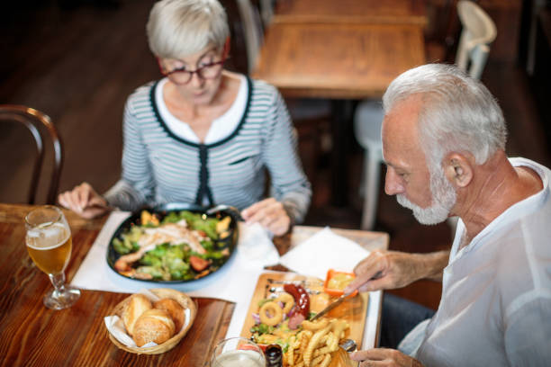 istock Senior couple eating in the restaurant 1047007568