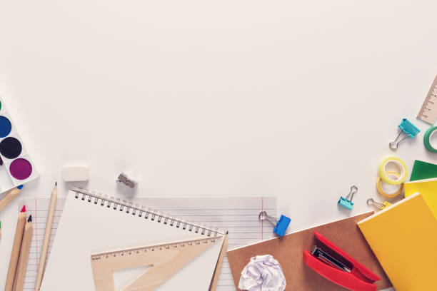 istock Top view over a notebooks, paints, pencils, rulers, paper clips, pins, calculator, glue, sharpener, pens, paper on a white background. Back to school concept. Office supplies flat lay 1047010374
