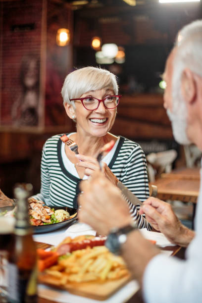 istock Senior couple eating in the restaurant 1047010540