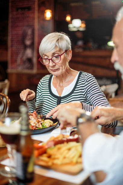 istock Senior couple eating in the restaurant 1047010724