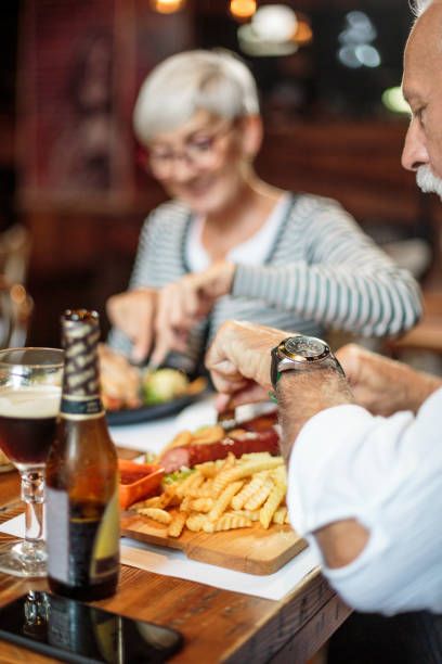 istock Senior couple eating in the restaurant 1047010728