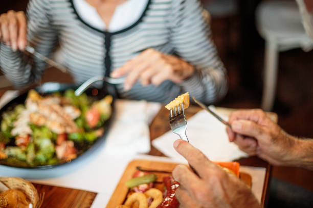 istock Senior couple eating in the restaurant 1047011060