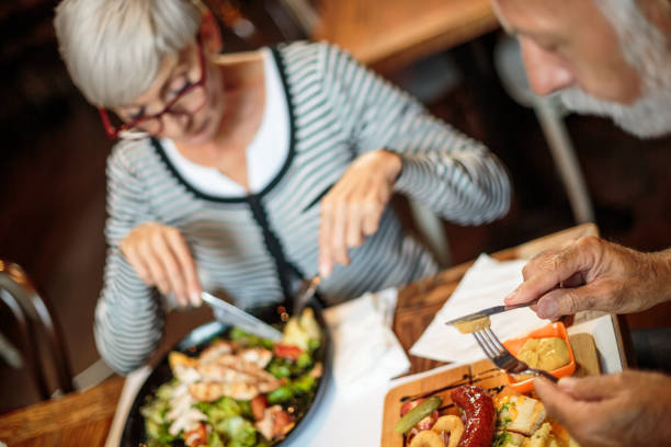 istock Active senior couple eating in the restaurant 1047011094