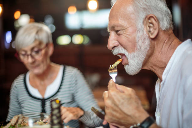 istock Senior couple eating in the restaurant 1047011254