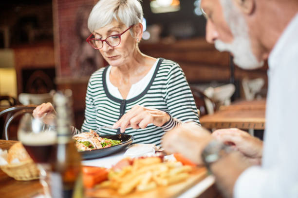 istock Senior couple eating in the restaurant 1047011308