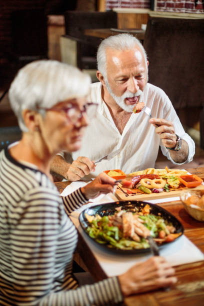 istock Senior couple eating in the restaurant 1047013370