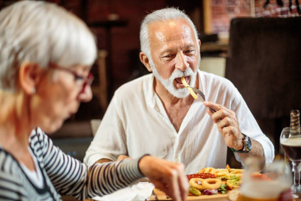 istock Senior couple eating in the restaurant 1047013542