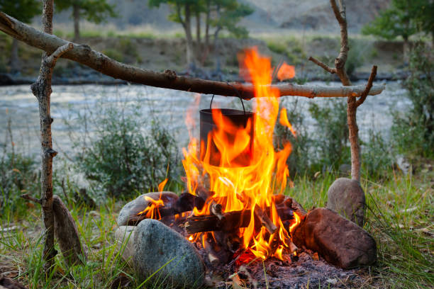 istock Cooking camp food in cauldron on open fire 1047013820