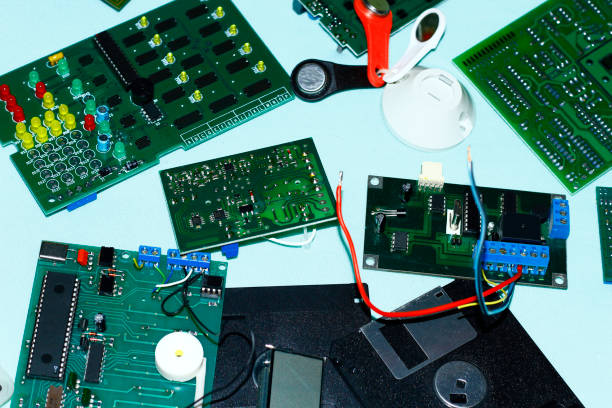 istock Electronic components printed circuit boards with magnifying glass in the foreground. 1047014106