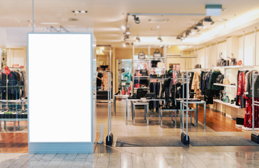 Clothes shop entrance with empty billboard mockup to place text, logo or advertisement