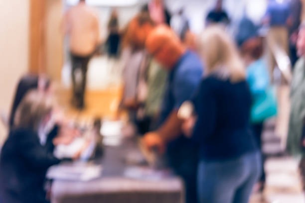 istock Blurry background participants check-in and queue  at registration table of conference 1047020172