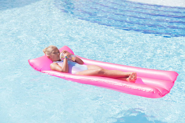 istock Joyful nice girl resting on the air bed 1047020322