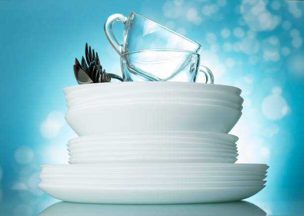 Set clean washed dishes and cups in beautiful bright blue background