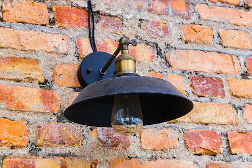 Vintage lamp in the brick wall background