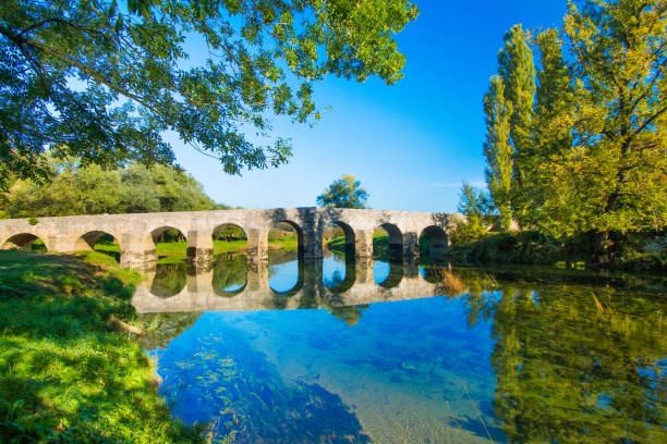 istock Bridge on the Dobra river, Croatia 1047027048