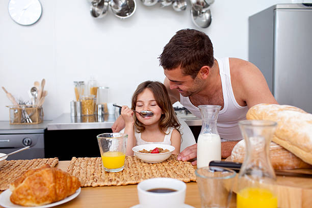 istock Little girl having breakfast with her father 104702725