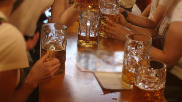 People Drinking Beer During Annual Beer Fest In Munich Germany. Europe People Drinking Beer During Annual Beer Fest In Munich Germany Europe large german beer steins stock pictures, royalty-free photos & images