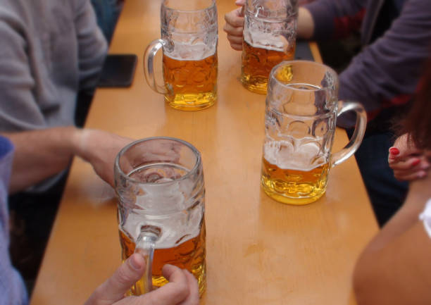 istock Beer Fest In Munich Germany Including People Drinking Beer With Big Cup 1047030988