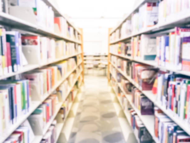istock Blurry background bookshelf aisles rows at public library in Texas, America 1047034546
