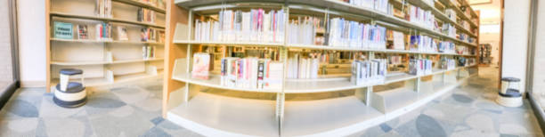 istock Panoramic blurry background bookshelf at public library in Texas, America 1047035326