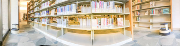 istock Panoramic blurry background bookshelf at public library in Texas, America 1047035430