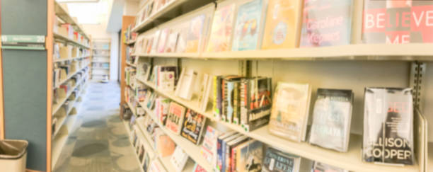 istock Panoramic blurry background bookshelf at public library in Texas, America 1047035622