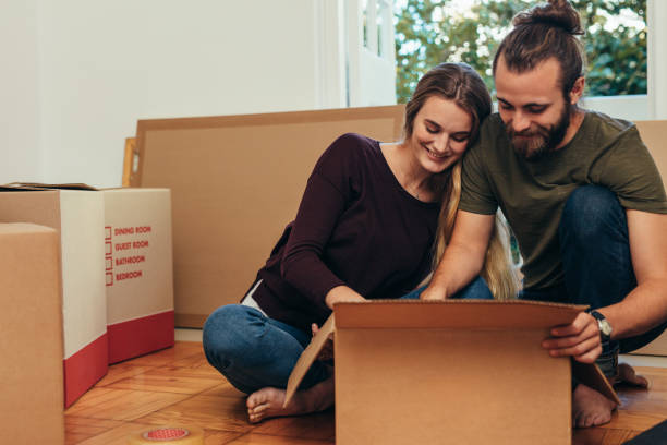 istock Happy couple looking at their articles packed in a box. 1047035728