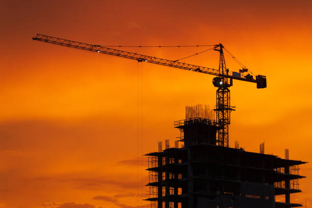 istock Silhouette crane in construction site at sunset 1047038726