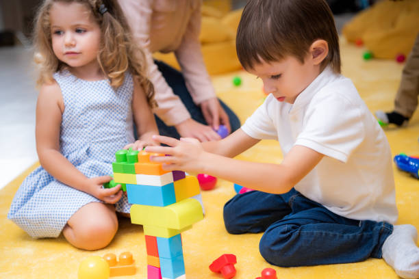 istock adorable kids playing with constructor in kindergarten 1047041324