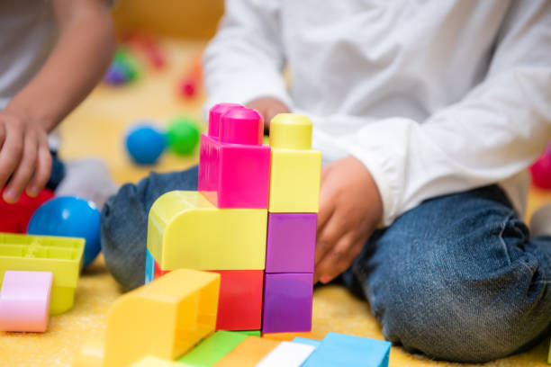 istock cropped image of african american kid playing with plastic constructor in kindergarten 1047041746