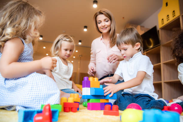 istock surface level of educator and kids playing with constructor in kindergarten 1047041788
