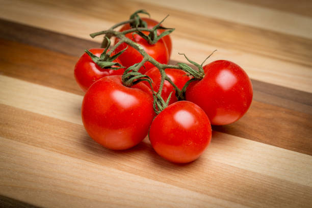 istock Cherry tomatoes on wooden cutting board 1047047458