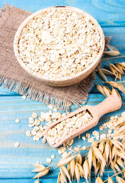 istock Oat flakes in a bowl on the blue board. 1047051560