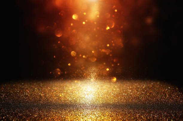 istock glitter vintage lights background. black and gold. de-focused. 1047053890