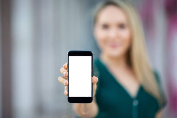 istock Woman showing a blank smartphone screen 1047054104
