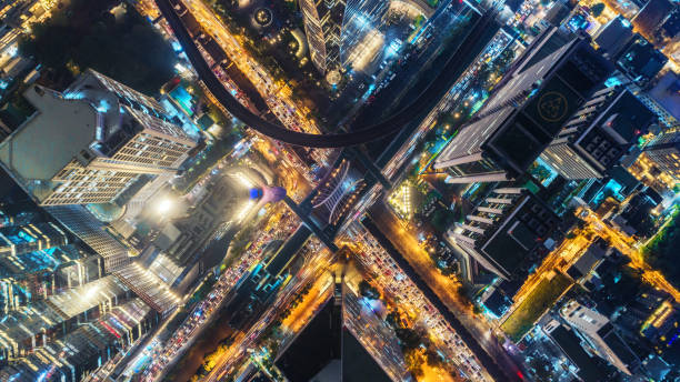 istock Aerial view highway road intersection at night for transportation, distribution or traffic background. 1047054326