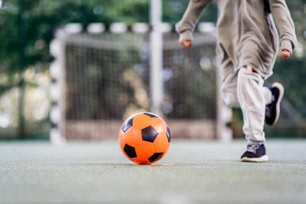 istock Boy play with football ball 1047054532