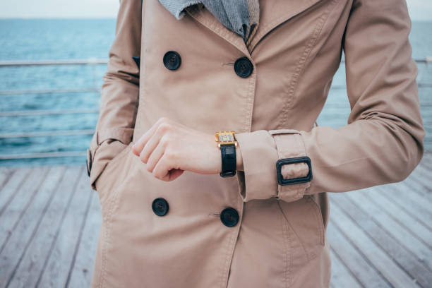 istock Young woman checking time on wrist watches 1047058154