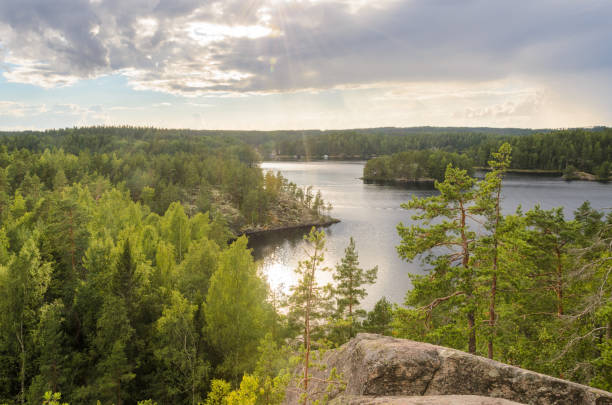 istock View from cliff over forest and lake. Finland. 1047059216
