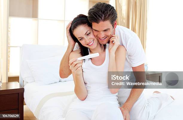 Enamored Couple Finding Out Results Of A Pregnancy Test Stock Photo - Download Image Now