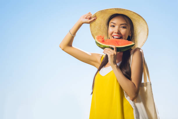 istock Joyful happy woman holding a watermelon piece 1047065626