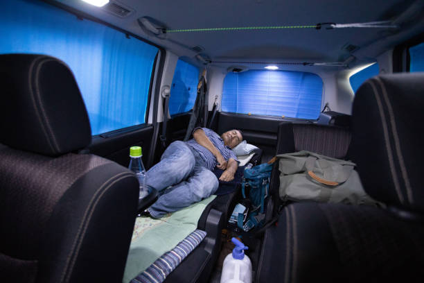 istock Senior man sleeping in his car 1047066138