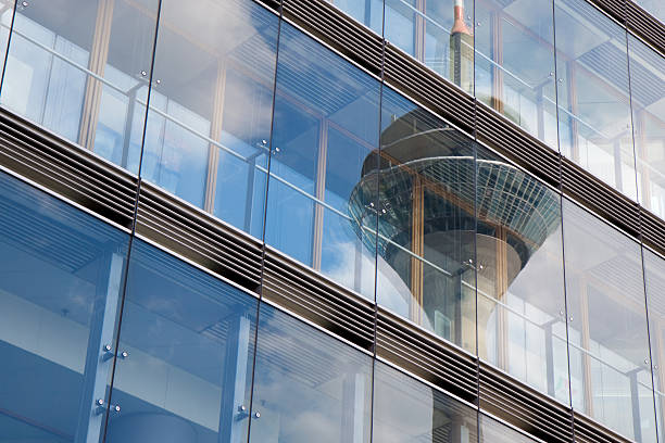 The image shows a just finished office building - architectural feature. View toward heaven on a cloudy day.