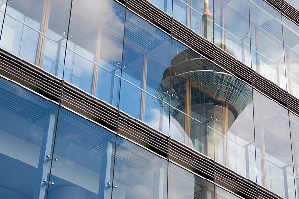 reflection of TV tower in glass facade stock photo