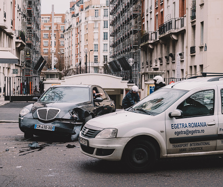 PARIS, FRANCE - JAN 30, 2018: Car accident on Paris street people helping debris recovery